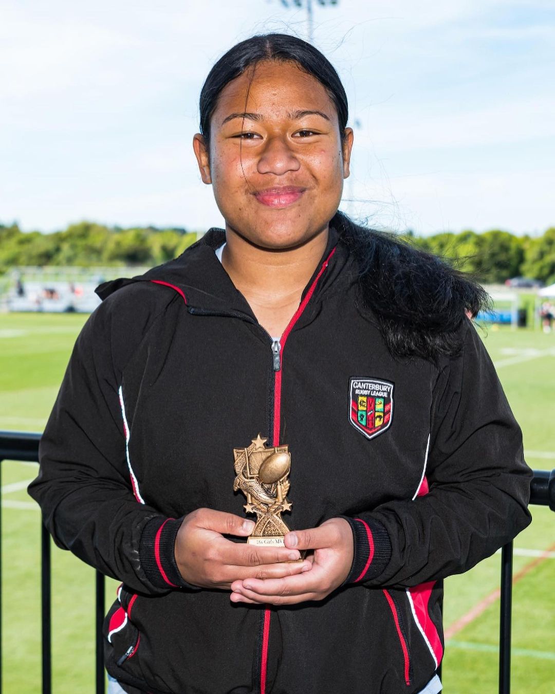 Young 15 year old woman with Award for representative rugby